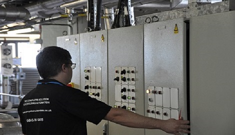 engineer carrying out maintenance of Building management system (BMS), automation and control panel